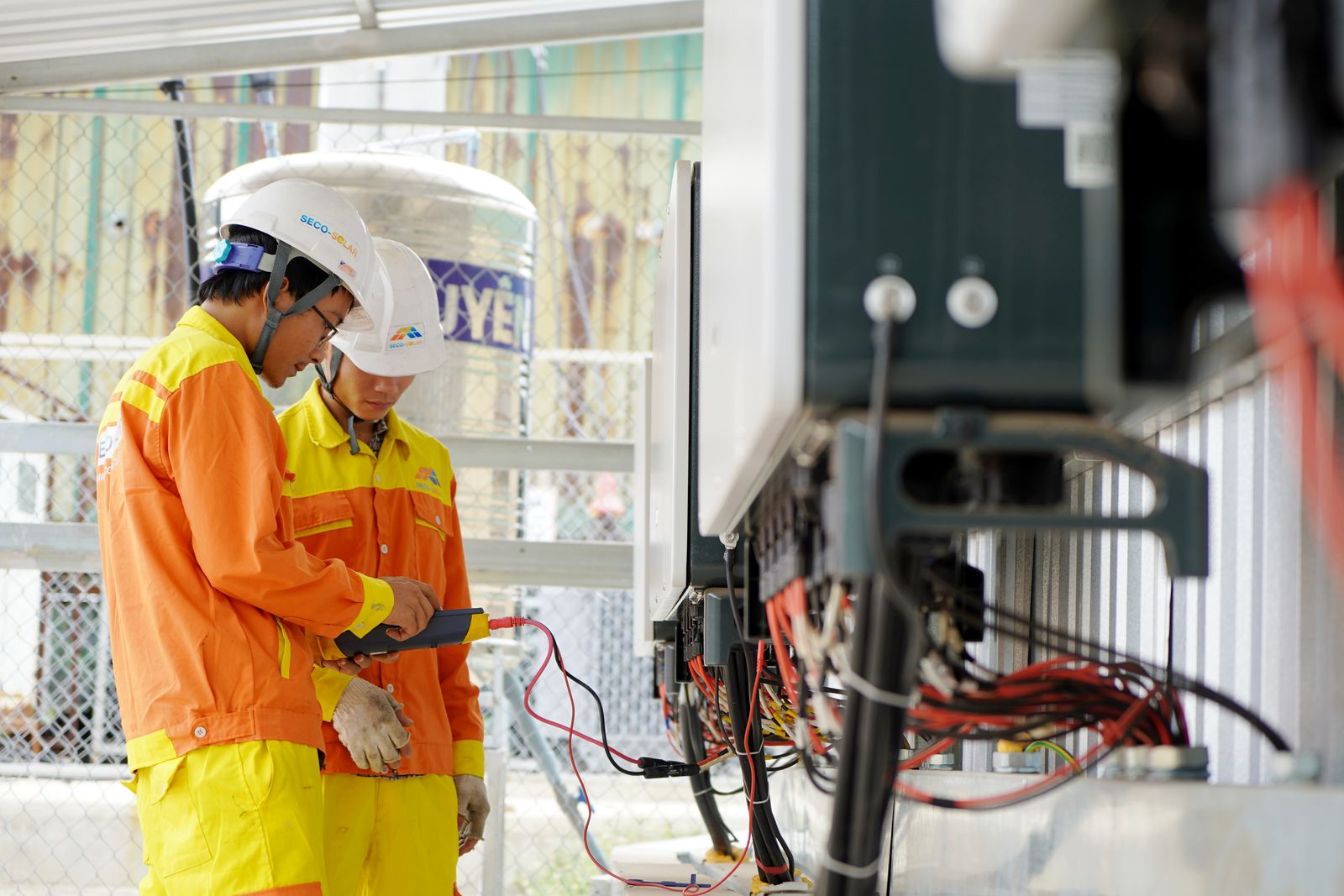 Zwei Servicetechniker prüfen eine technische Anlage bei der Wartung